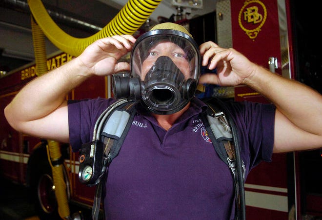 Bridgewater firefighter Paul Chuilli shows an oxygen mask that has a personal alert safety system attached to it on Tuesday. It was purchased with homeland security money.