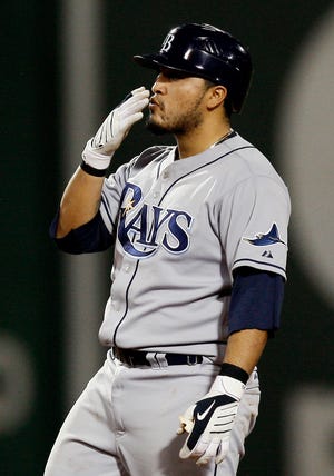 Dioner Navarro of the Rays blows a kiss to the Tampa Bay dugout after doubling in the go-ahead run during the ninth inning Monday night.
