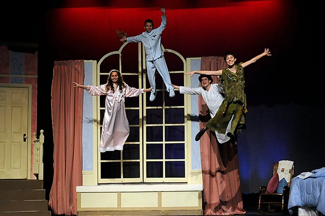 Wendy (Logen Hall), Michael (Kyle McIntyre), John (Ryan Barry) and Peter Pan (Bonnie Antosh) fly around the bedroom during a dress rehearsal of the Little Theater production of Peter Pan on Sept. 9, 2008. (Photo by John Byrum)