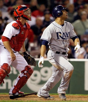The Rays' Carlos Pena watches his 3-run homer as Red Sox catcher David Ross (left) looks on in the 14th inning of last night's 4-2 Tampa Bay win.