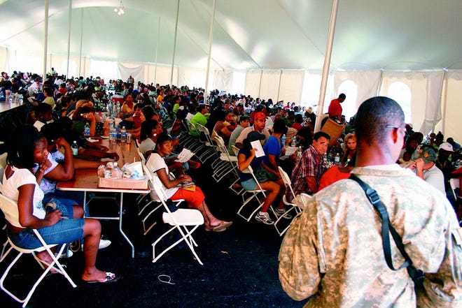 A National Guardsman stands at the entrance to a 500-person tent where applicants waited to apply for disaster relief food stamps at the Ascension Civic Center in Sorrento Tuesday. An estimated 2,000 to 3,000 people turned out, creating traffic problems on Airline Highway and requiring crowd control measures on the center grounds.