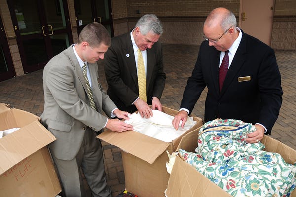 From left, Chris Jones with the Marriott, Mayor Bill Barnet and Dan Freeland with the Marriott, look over donated bedding material. The Spartanburg Marriott at Renaissance Park is upgrading, and it donated the old bedding from its 240-plus rooms to a number of local charities and organizations.