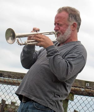 Cunningham/Democrat photo
Chris Elliot plays a somber tune during a Homeless Person's Memorial Day event held in Prescott Park in Portsmouth on Friday.