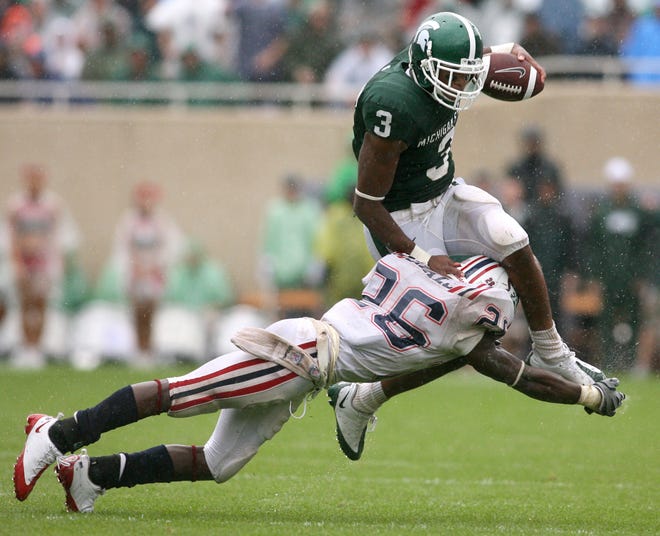 Michigan State's B.J. Cunningham (3) tries to hurdle Florida Atlantic's Corey Small following a pass reception during the second quarter of an NCAA college football game Saturday in East Lansing. MSU won 17-0.