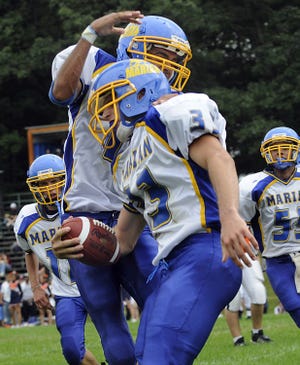 Mike Del La Femina (3) gets congratulated after scoring a touchdown during Marian's 43-13 win over Keefe Tech.