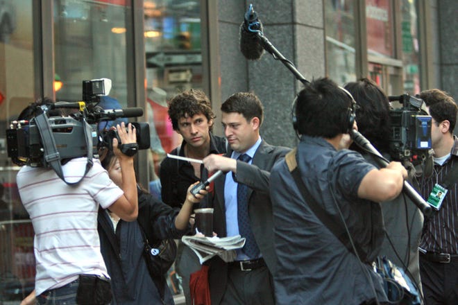 A man is surrounded by reporters as he arrives at the Lehman Brothers headquarters in New York, Monday. When Wall Street woke up Monday morning, two more of its storied firms had fallen. Lehman Brothers, burdened by $60 billion in soured real-estate holdings, filed a Chapter 11 bankruptcy petition in U.S. Bankruptcy Court after attempts to rescue the 158-year-old firm failed. Bank of America Corp. said it is snapping up Merrill Lynch & Co. Inc. in a $50 billion all-stock transaction.