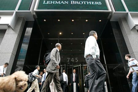 Morning commuters walk past the Lehman Brothers headquarters today in New York. U.S. stocks headed for a mixed open today, a day after Wall Street's worst day in years, as nervous investors awaited a decision from the Federal Reserve on interest rates.