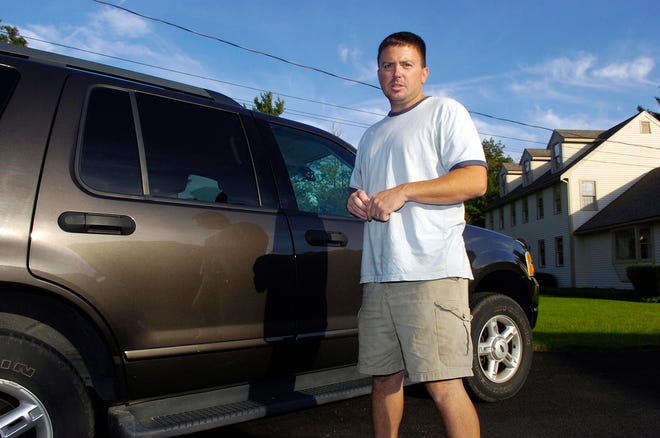 Paul Moreau of Brookside Drive in Bridgewater stands next to his Ford Explorer that was broken into this week.
