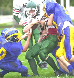 Galva’s Dalton Brody (left) and Jake McClintic (right) bring down Abingdon’s Matt DeJaynes with the help of an unidentified teammate during the first half of Monday night’s fresh-soph game in Galva. Abingdon defeated the Wildcats, 24-0.