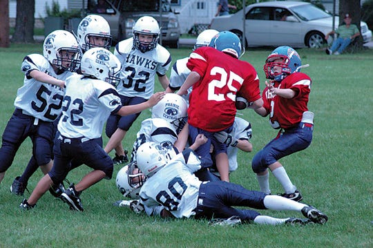 Prairie Central’s Junior White defense converges on Tri-Point’s ballcarrier during last weekend’s CIFL football game at George B. Ferree Field. The Hawks won 7-0.