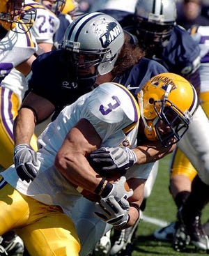 AP photo

UNH linebacker Matt Parent, top, wraps up Albany running back David McCarty, bottom, during the second quarter at Cowell Stadium Saturday.