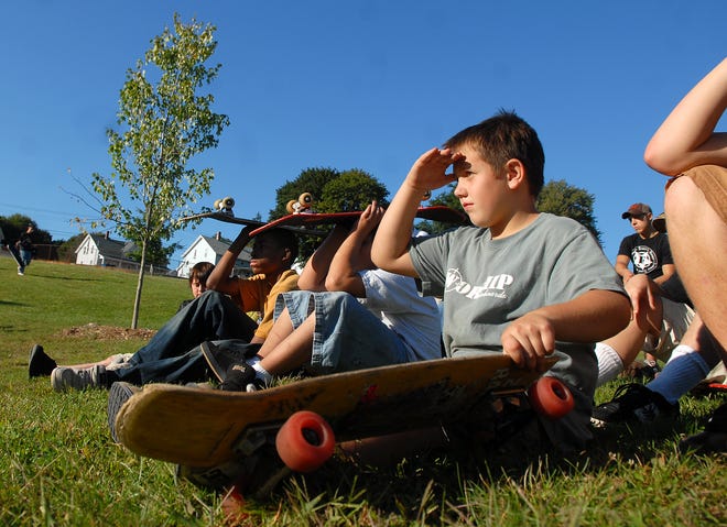 Owen McCarty, 9, of Jewett City, and other skateboarders listen to community leaders Saturday talk about the $120,000 grant recently awarded to build a skate park, playground and t-ball field in Jewett City.