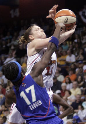 Sun guard Lindsay Whalen goes up for a shot Saturday as Liberty rookie Essence Carson goes for the block in their first-round WNBA playoff game at Mohegan Sun Arena. The Sun won, 73-70.
