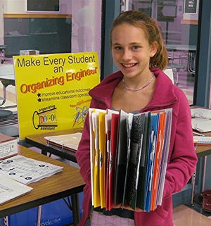 Franklin sixth-grader Elizabeth Fabian holds her new organizing system.
