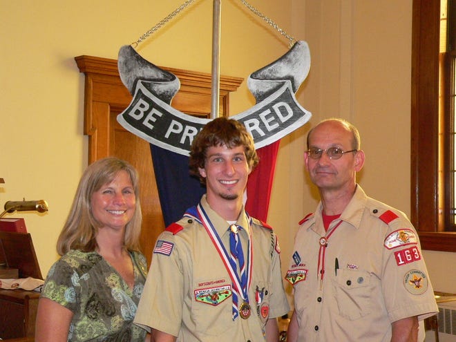 Top honors: Jonathan Vallosio, center, stands with his parents Jeff and Carol Vallosio after his Eagle Scout Court of Honor.