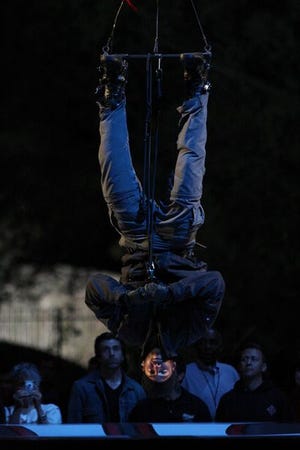 Magician David Blaine hangs upside down above Central Park's Wollman Rink in New York as he nears the end of his latest endurance challenge "David Blaine: Dive of Death" Wednesday night Sept. 24, 2008.