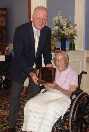 State Rep. Frank Hynes receives a plaque honoring his years of service from South Shore Resident Council president Gertrude Reynolds at Life Care Center in Scituate.