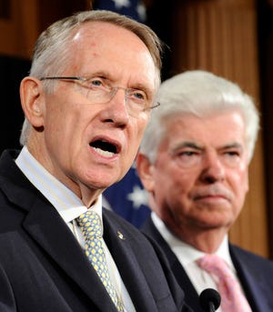 Senate Majority Leader Harry Reid, D-Nev., left, speaks as Senate Banking Committee Chairman Sen. Chris Dodd, D-Conn., right, listens during a news conference on Capitol Hill in Washington, Fridayon legislation to deal with the market turmoil.