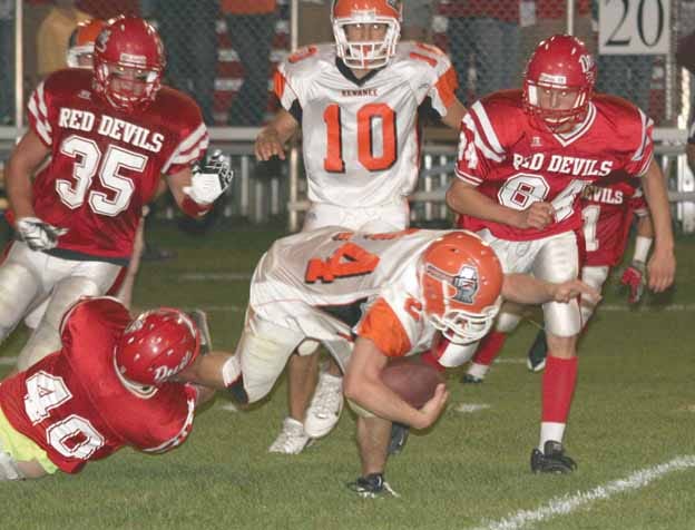 Kewanee’s Jacob Nimrick stretches for a few extra yards on a kick return against Hall Friday night. Looking on for the Boilers is Nick Butts (10).