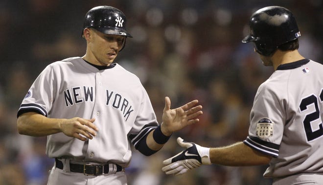 New York Yankees' Cody Ransom, left, is congratulated by teammate Xavier Nady after scoring on a double by Wilson Betemit against the Boston Red Sox in the seventh inning of their MLB baseball game at Fenway Park in Boston, Friday Sept. 26, 2008. (AP Photo/Charles Krupa)