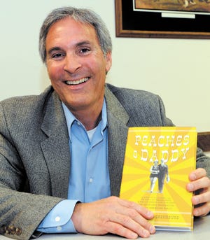 Author Michael Greenburg holds his new book "Peaches and Daddy."