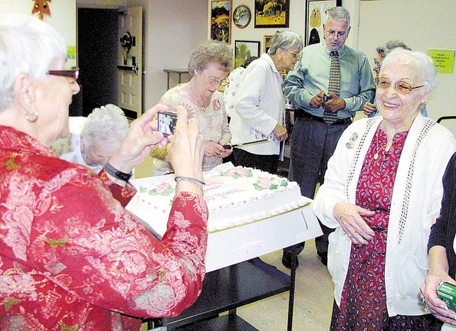 Jennie Marino, right, flashes her familiar smile at her 100th birthday celebration at the Mulberry Senior Center in Middletown.