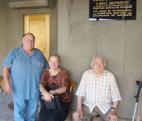 Jim Earl stands with two church members from the country of Georgia before the recent Russian invasion.