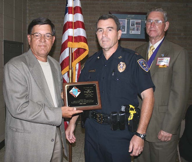 Chief Bill Landry presents the Gonzales Police Department Officer of the Year plaque to Sam Pasqua. The St. Theresa of Avila Knights of Columbus Council 2657 recognized four outstanding law enforcement officers at its 23rd Annual Law Enforcement Banquet, held Sept. 25 at the group’s meeting hall in Gonzales.