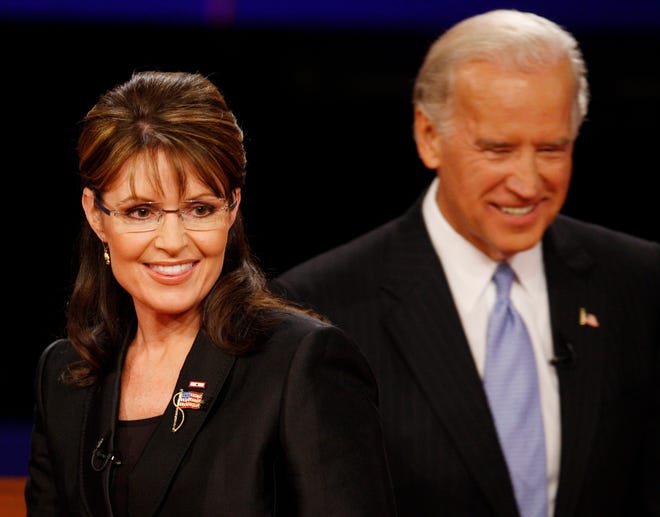 Republican vice presidential candidate Alaska Gov. Sarah Palin passes in front of Democratic vice presidential candidate Sen. Joe Biden, D-Del. after the vice presidential debate at Washington University in St. Louis, Mo., on Thursday.