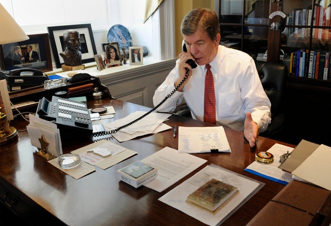 House Minority Whip Rep. Roy Blunt, R-Mo., talks on the phone with Rep. Joe Knollenberg, R-Mich., on the House financial bailout legislation in his office on Capitol Hill in Washington, Friday, Oct. 3, 2008. (AP Photo/Susan Walsh)