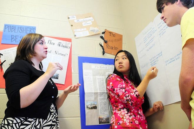 Malley Humber, left, explains differences between the Federalists and Antifederalists to students in her Advanced Placement U.S. History 10 class Wednesday during a class exercise at Northridge High School. Humber recieved a scholarship from the Tuscaloosa City School Board and is now in her first year teaching.