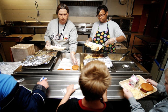 Angie Johnston (left) and Sarah Couch (right) serve lunch to Lincoln-Douglas Elementary students on Oct. 2, 2008.