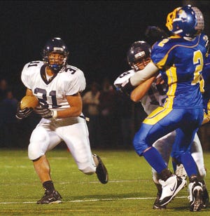 Victor’s Chuck Beckwith (31) tries to find open running room during Friday’s game at Irondequoit.