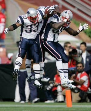 Kevin Faulk (33) celebrates with Sammy Morris (center) and Laurence Maroney after scoring a touchdown during the Patriots' win over the 49ers.
