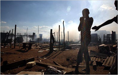 Squatters’ shacks smoldered at a makeshift settlement near Johannesburg.