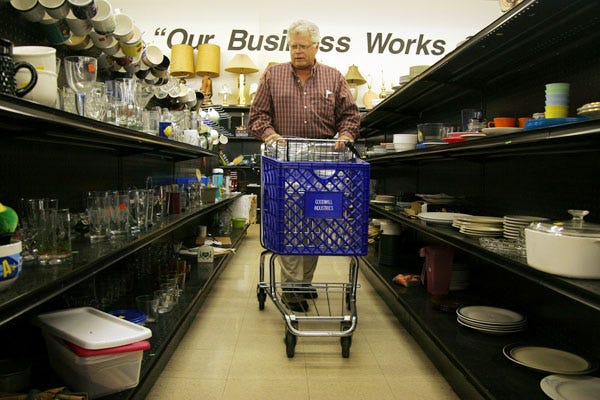 Tom Nordberg, a retired pastor from Columbia, Mo., shops for pint glasses and other glassware at a Goodwill store, Wednesday, Sept. 24, 2008, in Columbia, Mo.