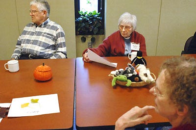 From left, Trevor Watson, Kathy Glaab and Wilma Owenson listen as a University of Missouri professor leads a discussion about colorful fall foliage yesterday at the MU Adult Day Connection in Clark Hall on campus. The program aims to keep adults engaged in their surroundings by offering exercise as well as arts and crafts.