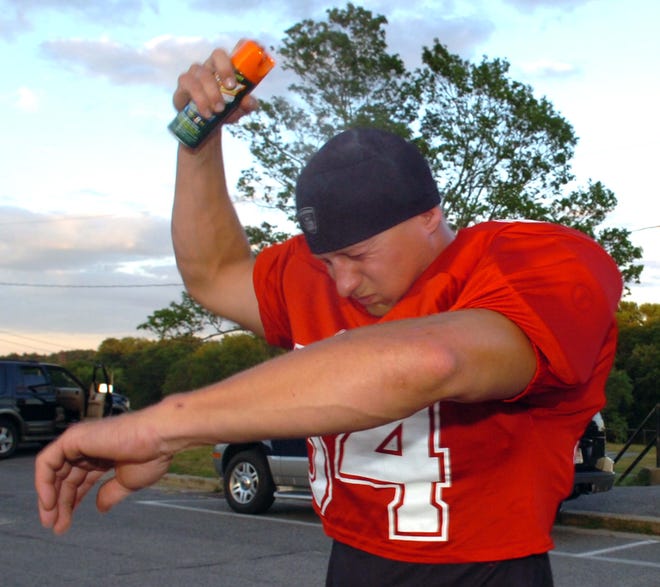 Dry weather has kept mosquito-borne illnesses down in Massachusetts this summer. Above, Brandon Soule of Middleboro sprays himself with bug repellant before playing a football game with the Middleboro Cobra in this 2006 file photo.