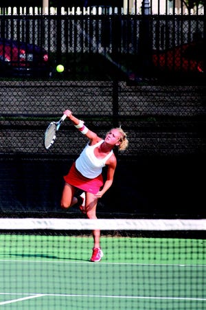 Amy Unzicker serves against Grinnell earlier this fall.