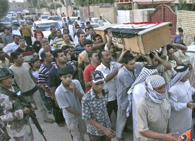 Relatives carry the coffin of Iraqi lawmaker Saleh al-Auqaeili outside his home in Baghdad yesterday.