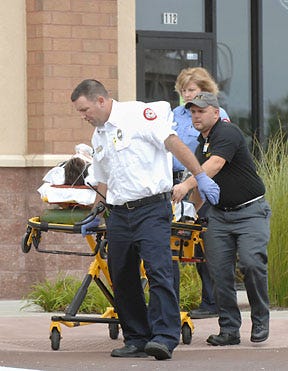 Columbia firefighters move 29-year-old Nic Parks to an ambulance at about 10:55 a.m. today after he received an electrical shock at The Game Room, 1020 Green Meadows Road, Suite 112. Parks, an employee of the store, was working on a video game when he was shocked and knocked unconscious, Columbia fire Battalion Chief Gary Warren said. He regained consciousness before emergency crews arrived and was alert when he was taken to University Hospital. Don Shrubshell
