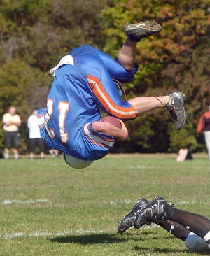 Holbrook/Avon running back Jeremy Gallagher is sent flying by West Bridgewater's Chris O'Connel.