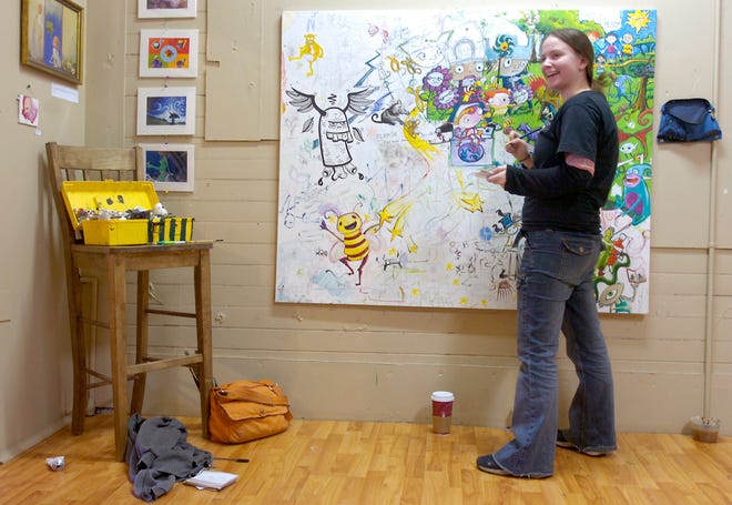 Artist Rachel Maguire, of Middleboro works in the gallery room at the Better Been Coffee Company in Bridgewater Square in this 2006 file photo. Maguire's art was recently selected for use on the First Night Boston 2009 admission button.
