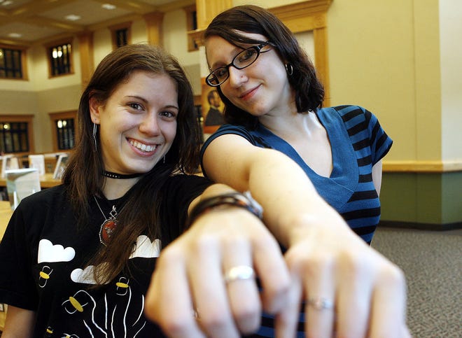 Sarah Marble, left, and Beverly Carpenter, both 17, show off their purity promise rings at Whitman-Hanson Regional High School. The rings symbolize their promise of chastity until marriage.