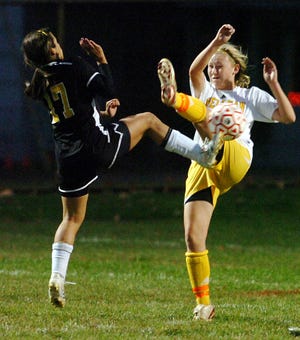 Spellman's Nicole McDonough, right, fights to block a shot by Fenwick's Kristin Verrette during Tuesday's game in Brockton.