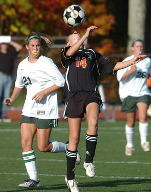 Kristina Simonson of Oliver Ames has her eye on the ball as Mansfield's Amanda Cunningham moves in.