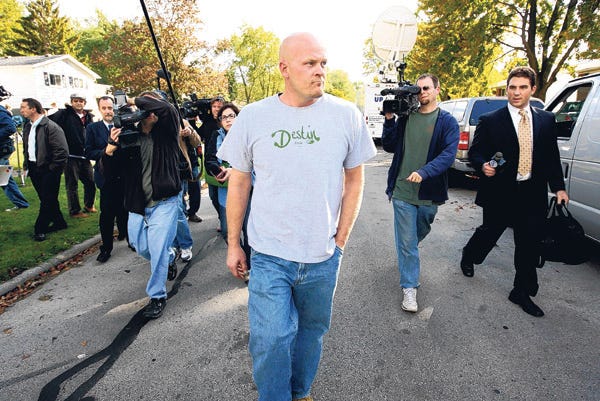 Joe Wurzelbacher walks to a neighbor's home followed by reporters in Holland, Ohio on Oct. 16. Wurzelbacher is better known as "Joe the Plumber," the nickname Republican John McCain bestowed on him during Wednesday's presidential debate with Democrat Barack Obama.