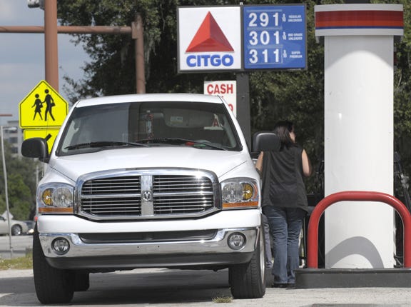 A customer gases up at the Majik Market at the intersection of U.S. Highway 17 and Avenue M, N.W. in Winter Haven on Wednesday where the posted price for regular gas is $2.91. Wednesday, October 15, 2008