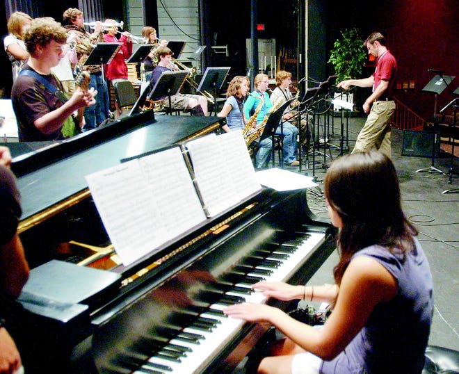 Two Canandaigua Academy jazz ensembles will play at a concert tomorrow evening. Above, Greg Kane leads one of the groups at a rehearsal.