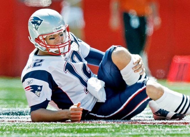 New England Patriots quarterback Tom Brady holds his leg after being hit by Kansas City Chiefs safety Bernard Pollard during the first quarter of an NFL football game Sunday, Sept. 7, 2008, in Foxborough, Mass. Brady has undergone a second surgical procedure on his injured knee Wednesday. The initial surgery was performed on his left knee on Oct. 6 but apparently became infected and required a second procedure.